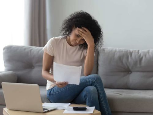 young african american woman stressed over bills