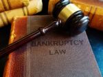 bankruptcy law books with a gavel on top
